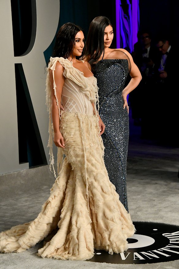 Kylie Jenner (right, with Kim Kardashian) has become one of the family's highest earners after selling  a majority stake in her cosmetics business.