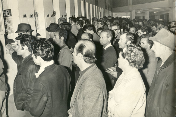 Punters queue up to place their bets at a Harold Park dog meeting. August 1969.