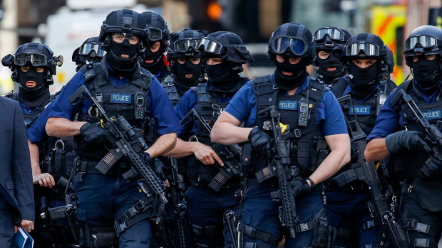 Armed police officers patrol streets near the scene of a terror attack in London in June last year.