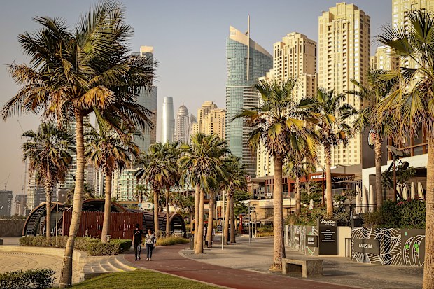 People walk through Dubai’s Jumeirah Beach Residence (JBR) district on July 21, 2026.