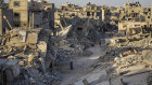 Palestinians walk through the destruction left by the Israeli air and ground offensive on Khan Younis, Gaza Strip.