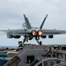 An E/A-18G Growler launches from the flight deck of the aircraft carrier USS Nimitz in the South China Sea.