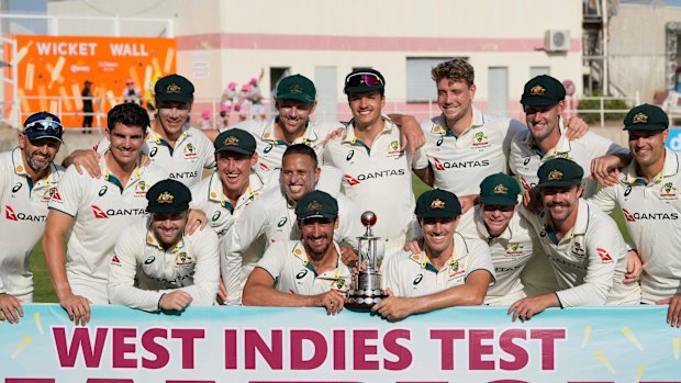 Australia players pose with the trophy after day day three of their third Test cricket match against West Indies at Sabina Park in Kingston, Jamaica, 