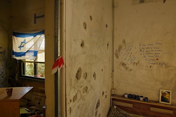 Tributes are written on the wall inside the dental health facility where five people were killed by Hamas during the October 7 Hamas attack.
