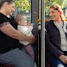 Macarthur Heights residents Antonella Panozzo and her daughter Ruby, 11 months, travel on the new bus with local Veenu Chawlla.