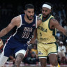 Boomers icon Patty Mills tries to defend US star Jayson Tatum on a drive to the basket.