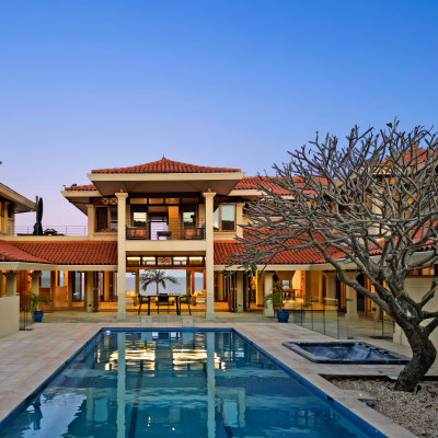 Former billionaire halves asking price for palatial beachfront home