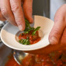 A lab-grown lamb meatball, being plated by chef Garth Channing.