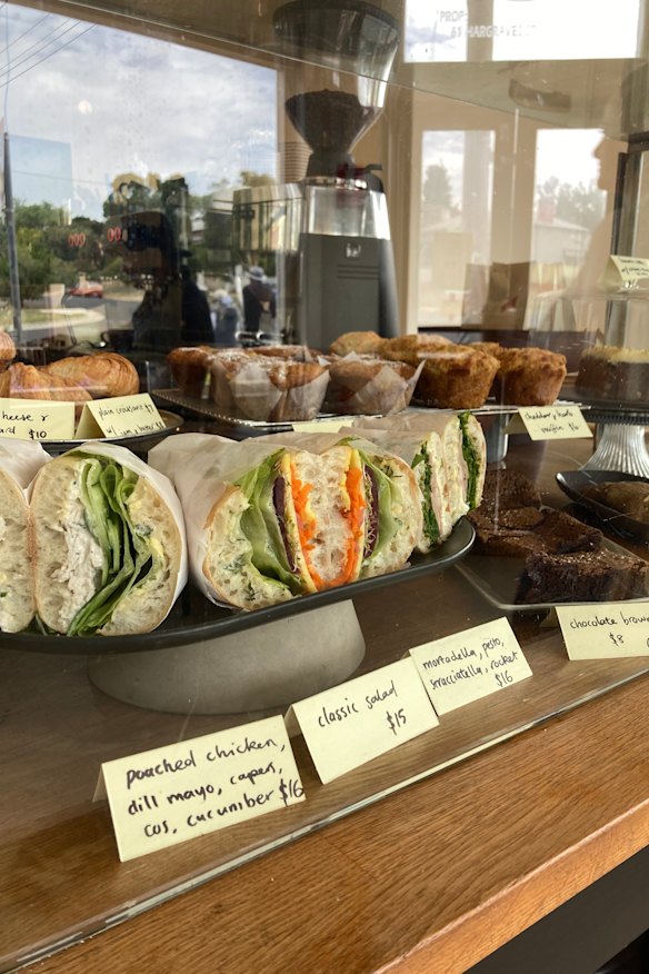 A selection of sandwiches and baked goods are available at the counter.