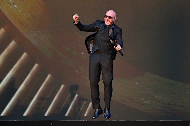 Pitbull celebrates onstage after he was presented with the Guinness World Record title 