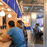 Bright blue noren (bunting) surrounds the bar counter.