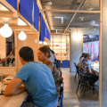 Bright blue noren (bunting) surrounds the bar counter.