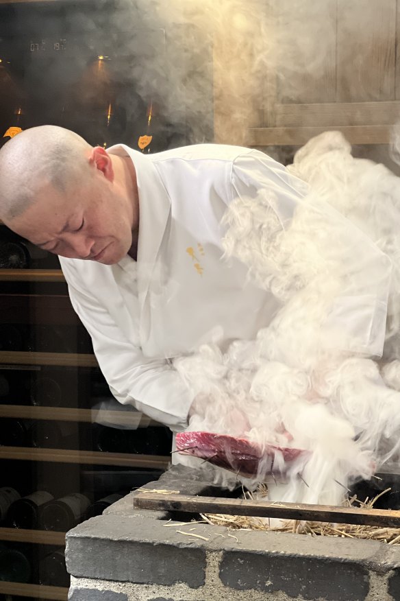 Chef Masamichi Amamoto prepares hay-smoked bonito at Tokyo omakase restaurant Higashiazabu Amamoto.