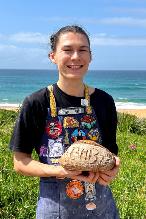 Burnt Honey Bakery baker Matty Castle with a loaf of their sourdough bread.