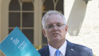 Prime Minister Scott Morrison with the report from the Royal Commission into Aged Care Quality and Safety. 