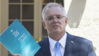Prime Minister Scott Morrison with the report from the Royal Commission into Aged Care Quality and Safety. 