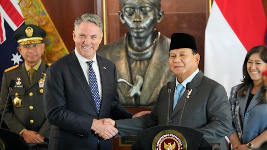 Indonesian Defense Minister Prabowo Subianto, right, shakes hands with Australian Deputy Prime Minister and Defense Minister Richard Marles following their meeting in Jakarta, Indonesia, Friday, Feb. 23, 2024. (AP Photo/Achmad Ibrahim)