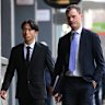 Western United player Riku Danzaki (left) arrives at Melbourne Magistrates’ Court to face allegations of deliberately receiving yellow cards in a match.