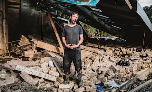 Falomir in the rubble of what was his space at Silver Cloud Studios. His studio roof collapsed and much of his tools and stained glass washed away.