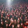 People using face masks take part in a music concert in Barcelona, Spain.