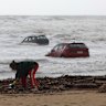 Locals begin cleaning up in Wye River on Friday morning after intense flooding.