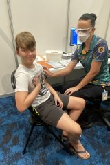 Eli Doumani, 11, receives his first dose of the COVID-19 vaccine at Cairns Convention Centre on Monday morning. 