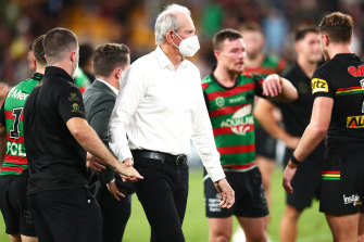 Wayne Bennett consoles South Sydney players after Sunday’s grand final defeat.