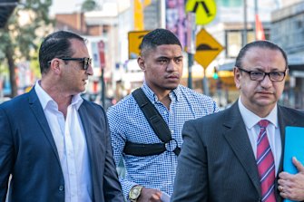 Manase Fainu (centre) arriving at Liverpool police station at the start of his legal battle in October, 2019.