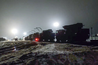 Russian military vehicles prepares to drive off a railway platforms after arrival in Belarus in January..