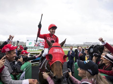 Mind on the job: Kerrin McEvoy raises his whip in victory after Saturday's Everest on Redzel.