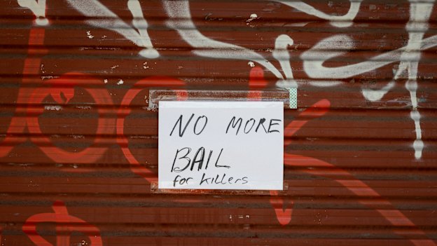 A handwritten sign was taped to the grocery’s roller door.