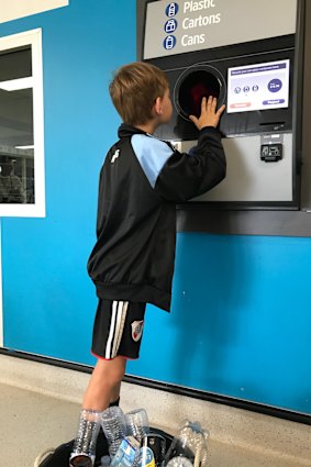 St Joseph’s Corinda year 4 student Xavier Anderson recycles a container.