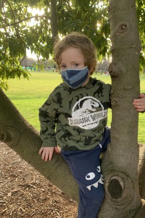 Griffin Williams, 5, sports a mask and the latest  dinosaur gear.
