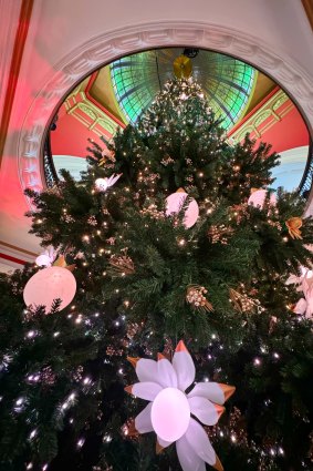 The Christmas tree in the QVB is suspended from a winch from the dome.