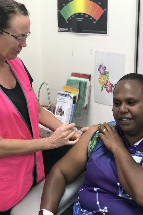 Nurse Ruth Ferguson vaccinates Saibai Island school teacher Norah Tabuai. 