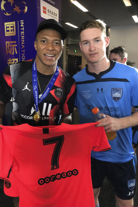 Parting gift: Sydney FC's Harry Van der Saag is given Kylian Mbappe's match shirt in his starting debut.