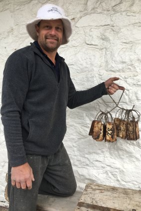 Andy Van der Wacht with the historic tags unearthed in the foundations of the Cobb &amp; Co coach stables at The Sir George in Jugiong.