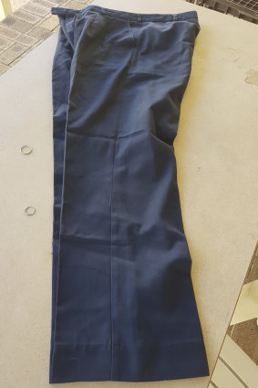 Telstra-issued work trousers from around the 1990s period. State prosecutors argue the fibres pulled from tape lifts by forensics officers match the same brand of pants.