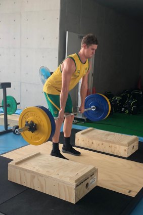 Lifting their intensity: Alex Graham at the Dolphins gym training ahead of the Pan Pacs. 