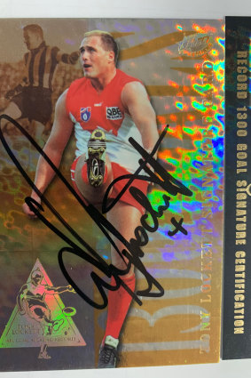 A Tony Lockett 1300-goal signature card on the market for $4500. Lucky collectors will find a voucher card in their winning pack. They will then send that to the manufacturer to redeem the signed card