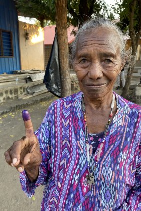 A Timor-Leste woman shows the ink on her finger that proves she has voted.