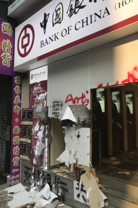 Protesters smashed the entrance to a Bank of China branch.