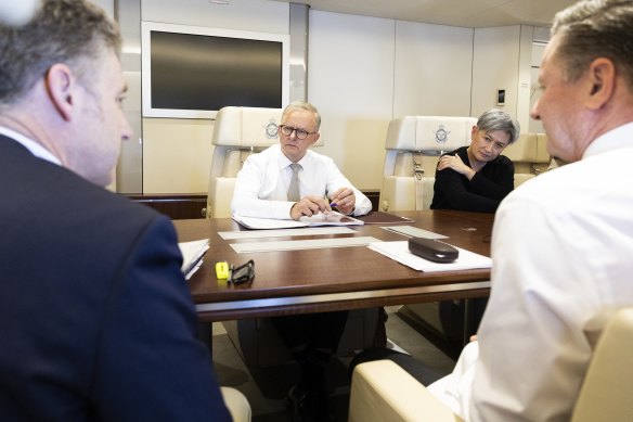 Prime Minister Anthony Albanese and Foreign Affairs Minister Penny Wong during a meeting on the flight from Canberra to Tokyo on Monday to attend the Quad leaders’ summit.