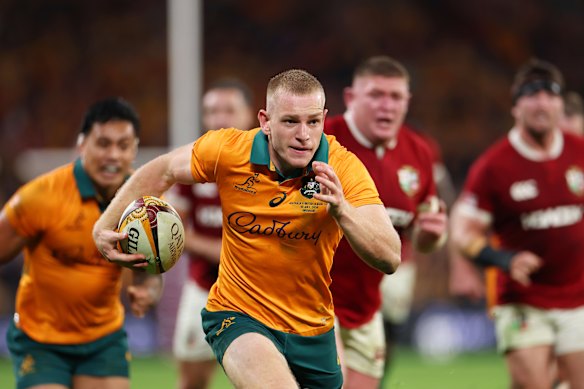 Max Jorgensen of the Wallabies breaks away to score a try.