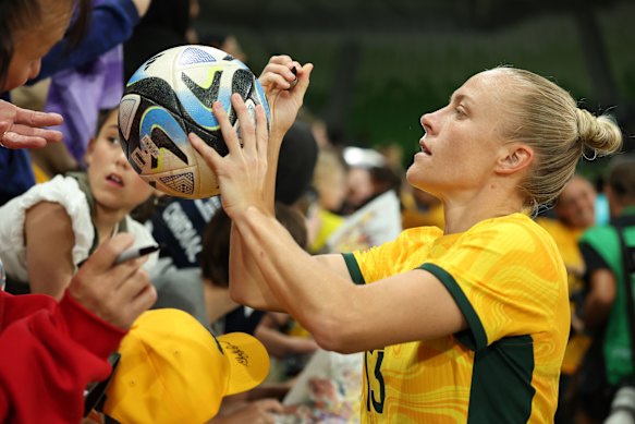 Tameka Yallop of Australia signs autographs for fans.