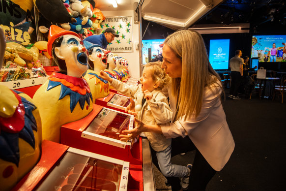 Carlie Young and son Arlo try their luck on the clown mouth game.