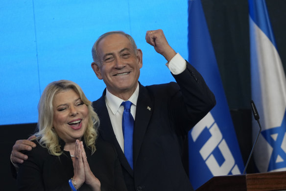 Former Israeli Prime Minister and the head of Likud party, Benjamin Netanyahu and his wife Sara gesture after first exit poll results for the Israeli Parliamentary election at his party’s headquarters in Jerusalem, on Wednesday.