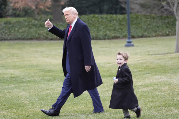 President Donald Trump walks with Elon Musk’s son X Æ A-Xii to his helicopter on the South Lawn of the White House on Friday.