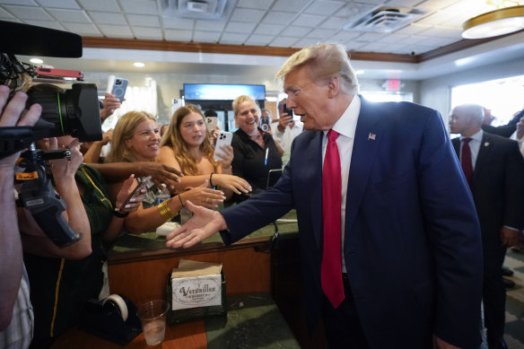 Much loved by Republicans, Trump greets fans at a Florida restaurant after his second indictment, in June.