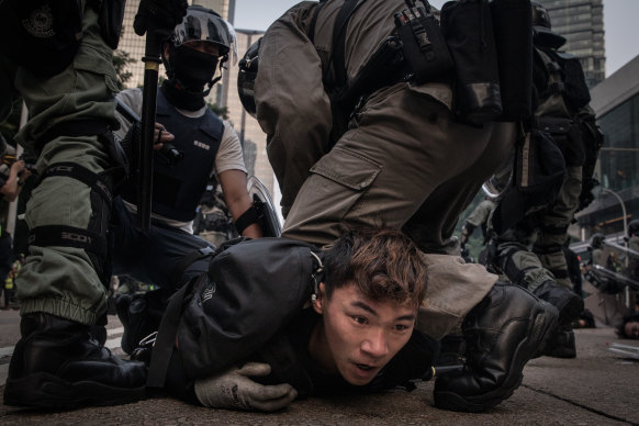 A pro-democracy protester in Hong Kong is tackled and arrested by police in September, 2019. 